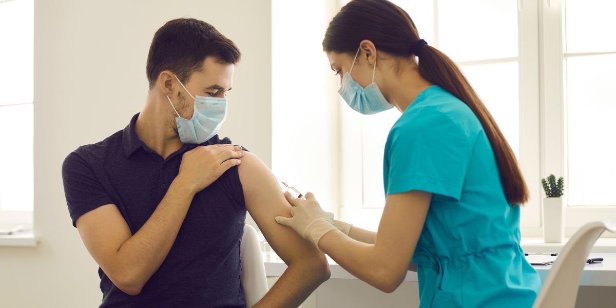 Nurse administering HPV vaccination shot to a man to protect health and prevent disease